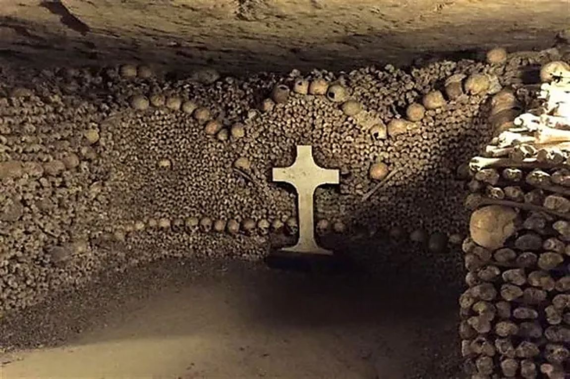 A gallery lined with the bones of the dead, and a cross