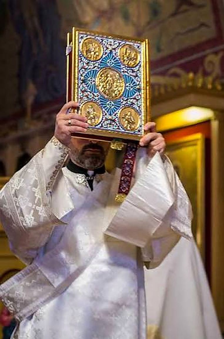 The Gospel book lifted up