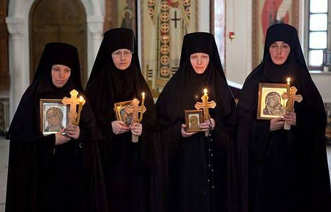 Nuns carrying icons